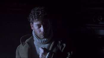 Movie still from “Below” (2002), directed by David Twohy – A man in a sweater and a jacket; Close Up shot, Low angle