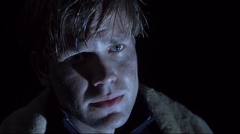 Movie still from “Below” (2002), directed by David Twohy – A person wearing a jacket; Close Up shot, Low angle
