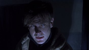 Movie still from “Below” (2002), directed by David Twohy – A person wearing a jacket; Close Up shot, Low angle