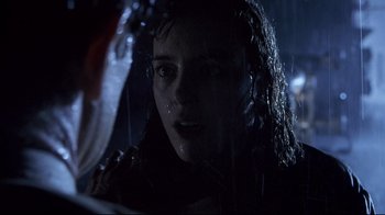 Movie still from “Below” (2002), directed by David Twohy – A person with wet hair in the dark; Close Up shot, Over the shoulder angle