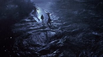 Movie still from “Below” (2002), directed by David Twohy – Two people standing in the water on a boat; Extreme Wide shot, High angle