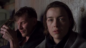Movie still from “Below” (2002), directed by David Twohy – A man and a woman standing next to each other; Close Up shot, Over the shoulder angle
