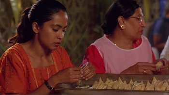Two women sitting at a table with a tray of food in front of them