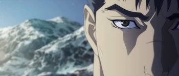 A man's face with mountains in the background