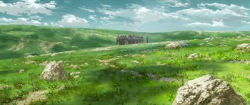 A group of people standing on top of a lush green hillside