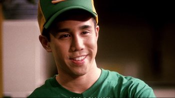 Movie still from “Better Luck Tomorrow” (2002), directed by Justin Lin – A young man wearing a baseball cap and a green shirt; Close Up shot, High angle