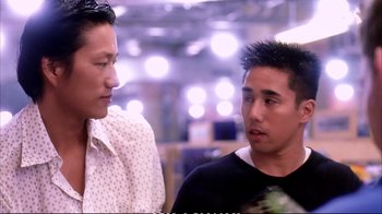 Movie still from “Better Luck Tomorrow” (2002), directed by Justin Lin – Two young men talking to each other in front of lights in the background; Close Up shot, Over the shoulder angle