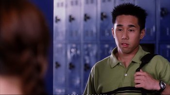 Movie still from “Better Luck Tomorrow” (2002), directed by Justin Lin – A man in a green shirt is in front of some lockers; Close Up shot, High angle