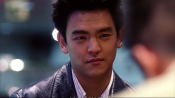 Movie still from “Better Luck Tomorrow” (2002), directed by Justin Lin – A person wearing a leather jacket; Close Up shot, Over the shoulder angle