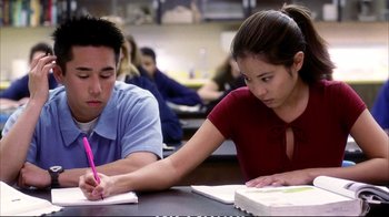 Movie still from “Better Luck Tomorrow” (2002), directed by Justin Lin – Two people sitting at a table writing on a notebook; Medium shot, High angle