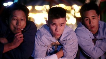 Movie still from “Better Luck Tomorrow” (2002), directed by Justin Lin – A group of young men sitting next to each other; Medium shot, Low angle
