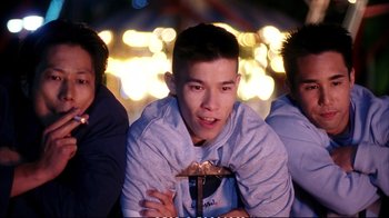 Movie still from “Better Luck Tomorrow” (2002), directed by Justin Lin – A group of young men sitting next to each other at night; Medium shot, Low angle