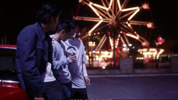 Movie still from “Better Luck Tomorrow” (2002), directed by Justin Lin – Three young men standing next to each other on the street; Medium shot, Over the shoulder angle