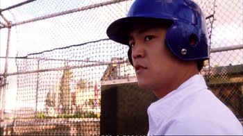 Movie still from “Better Luck Tomorrow” (2002), directed by Justin Lin – A baseball player is wearing a blue helmet; Close Up shot, Low angle