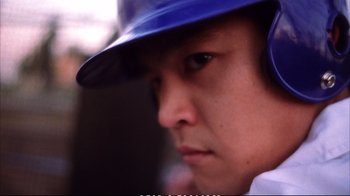Movie still from “Better Luck Tomorrow” (2002), directed by Justin Lin – A baseball player wearing a blue hat; Extreme Close Up shot, Low angle