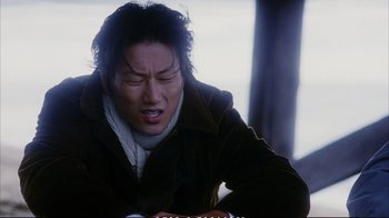 Movie still from “Better Luck Tomorrow” (2002), directed by Justin Lin – A man in a brown jacket looking down at a book; Close Up shot, Low angle