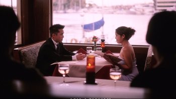 Movie still from “Better Luck Tomorrow” (2002), directed by Justin Lin – A man and a woman are sitting at a table; Medium shot, High angle