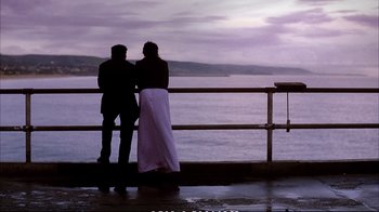 Movie still from “Better Luck Tomorrow” (2002), directed by Justin Lin – A man and a woman standing next to a railing near a body of water; Wide shot, Low angle