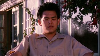 Movie still from “Better Luck Tomorrow” (2002), directed by Justin Lin – A young man in a tan shirt is looking at the camera; Close Up shot, Low angle