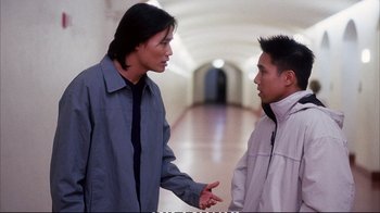 Movie still from “Better Luck Tomorrow” (2002), directed by Justin Lin – Two young men talking in a hallway of a building; Medium shot, High angle