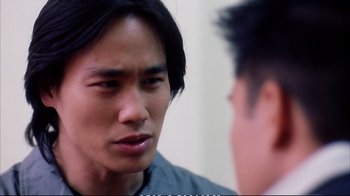 Movie still from “Better Luck Tomorrow” (2002), directed by Justin Lin – A man is looking at another man in the mirror; Close Up shot, Over the shoulder angle