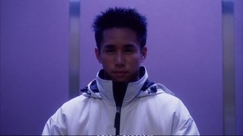 Movie still from “Better Luck Tomorrow” (2002), directed by Justin Lin – A young man in a white jacket is looking at the camera; Close Up shot, Low angle