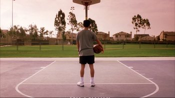 Movie still from “Better Luck Tomorrow” (2002), directed by Justin Lin – A man holding a basketball on top of a basketball court; Wide shot, High angle