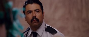 Movie still from “Beverly Hills Chihuahua” (2008), directed by Raja Gosnell – A man in a police uniform looking at the camera; Close Up shot, Low angle