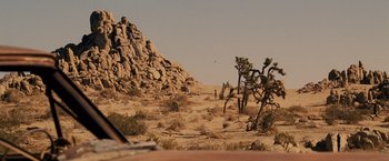 Movie still from “Beverly Hills Chihuahua” (2008), directed by Raja Gosnell – A large rock formation in the middle of the desert; Extreme Wide shot, Over the shoulder angle