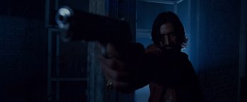 Movie still from “Beverly Hills Chihuahua” (2008), directed by Raja Gosnell – A man holding a gun in a dark room; Medium shot, Low angle