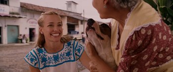 Movie still from “Beverly Hills Chihuahua” (2008), directed by Raja Gosnell – A woman smiling at a dog with a woman petting it; Close Up shot, Over the shoulder angle
