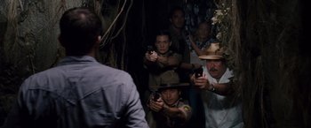 Movie still from “Beverly Hills Chihuahua” (2008), directed by Raja Gosnell – A group of people standing in a room holding guns; Medium shot, High angle
