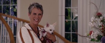 Movie still from “Beverly Hills Chihuahua” (2008), directed by Raja Gosnell – A woman holding a small white dog in her arms; Medium shot, Low angle