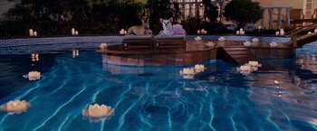 Movie still from “Beverly Hills Chihuahua” (2008), directed by Raja Gosnell – Two dogs sitting in a boat in the middle of a swimming pool; Wide shot, High angle