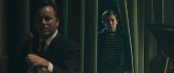 Movie still from “Beyond the Sea” (2004), directed by Kevin Spacey – A young boy standing in front of a mirror; Medium shot, Over the shoulder angle