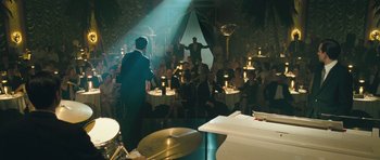 Movie still from “Beyond the Sea” (2004), directed by Kevin Spacey – A group of people sitting in a room with lights; Wide shot, High angle