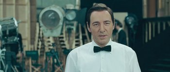Movie still from “Beyond the Sea” (2004), directed by Kevin Spacey – A man wearing a white shirt and a bow tie; Close Up shot, Over the shoulder angle