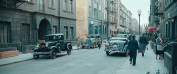 Movie still from “Beyond the Sea” (2004), directed by Kevin Spacey – An old photo of some old cars on the street; Wide shot, High angle