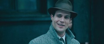 Movie still from “Beyond the Sea” (2004), directed by Kevin Spacey – A man wearing a hat and a coat; Close Up shot, Over the shoulder angle