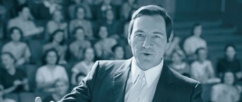 Movie still from “Beyond the Sea” (2004), directed by Kevin Spacey – A black and white photo of a man in front of a crowd; Close Up shot, Low angle
