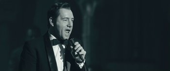 Movie still from “Beyond the Sea” (2004), directed by Kevin Spacey – A black and white photo of a man in a tuxedo singing; Close Up shot, Low angle