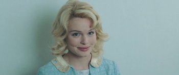 Movie still from “Beyond the Sea” (2004), directed by Kevin Spacey – A woman with blonde curly hair wearing a light blue jacket; Close Up shot, Over the shoulder angle