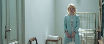 Movie still from “Beyond the Sea” (2004), directed by Kevin Spacey – A woman in a blue dress holding a white purse; Medium shot, High angle