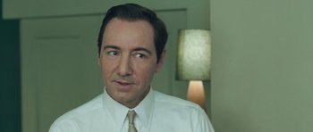 Movie still from “Beyond the Sea” (2004), directed by Kevin Spacey – A person wearing a shirt and a tie; Close Up shot, Over the shoulder angle