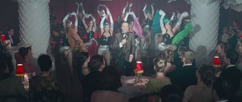 Movie still from “Beyond the Sea” (2004), directed by Kevin Spacey – A group of men and women in costumes performing a show; Medium shot, High angle