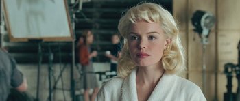 Movie still from “Beyond the Sea” (2004), directed by Kevin Spacey – A woman with blonde hair and a white bathrobe; Close Up shot, Over the shoulder angle