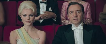 Movie still from “Beyond the Sea” (2004), directed by Kevin Spacey – A man and a woman sitting next to each other in formal wear; Close Up shot, Low angle