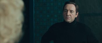 Movie still from “Beyond the Sea” (2004), directed by Kevin Spacey – A man in a black sweater standing in front of a wall; Close Up shot, Low angle