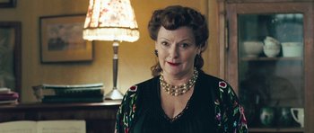 Movie still from “Beyond the Sea” (2004), directed by Kevin Spacey – An older woman wearing a black dress and pearls; Close Up shot, Low angle