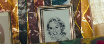 Movie still from “Beyond the Sea” (2004), directed by Kevin Spacey – A portrait of a woman in a gold picture frame; Extreme Close Up shot, Overhead angle